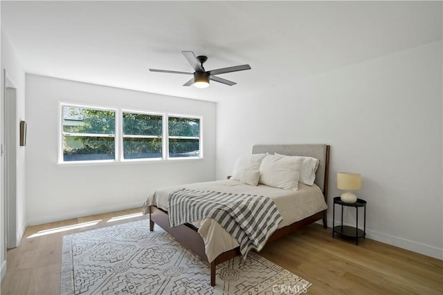 bedroom with ceiling fan and light hardwood / wood-style flooring