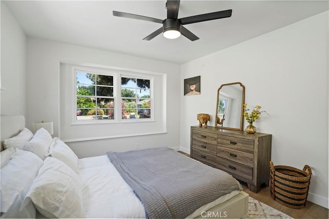 bedroom with ceiling fan and light hardwood / wood-style flooring