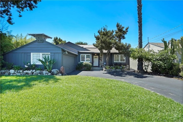 view of front of house featuring a front yard, a garage, and solar panels