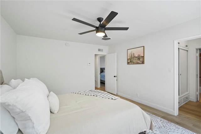 bedroom with ceiling fan and light hardwood / wood-style flooring