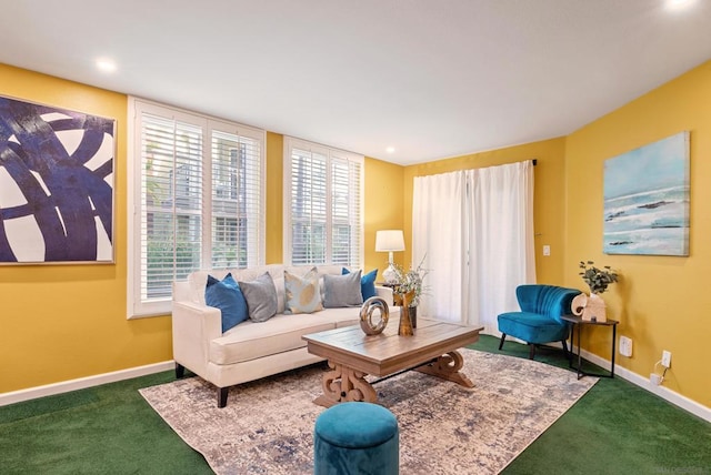 living room with a wealth of natural light and dark colored carpet