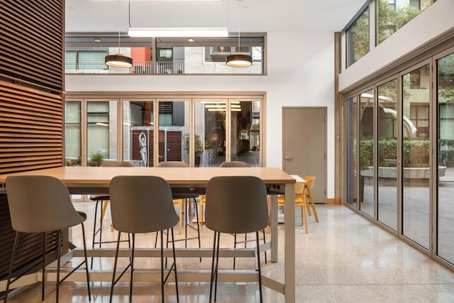 dining area with a towering ceiling