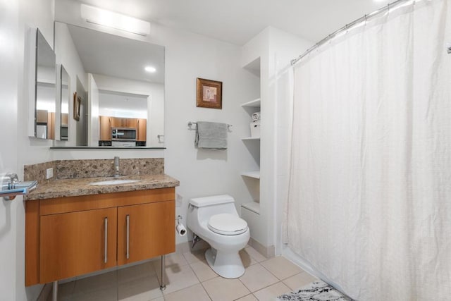 bathroom featuring tile patterned flooring, vanity, and toilet