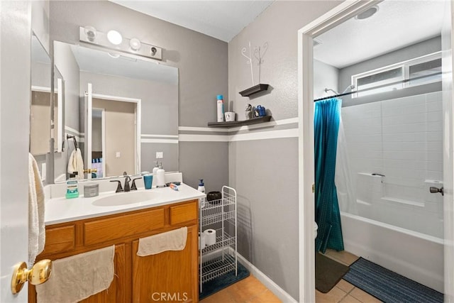 bathroom with shower / bath combo with shower curtain, vanity, and tile patterned flooring