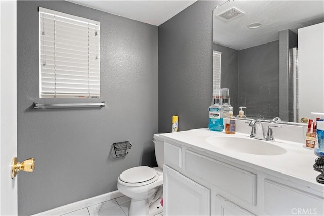 half bathroom featuring baseboards, visible vents, a textured wall, toilet, and vanity