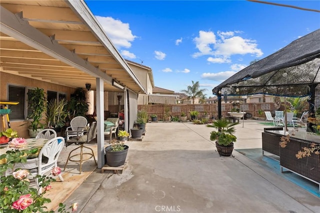 view of patio / terrace with a gazebo, outdoor dining area, and fence