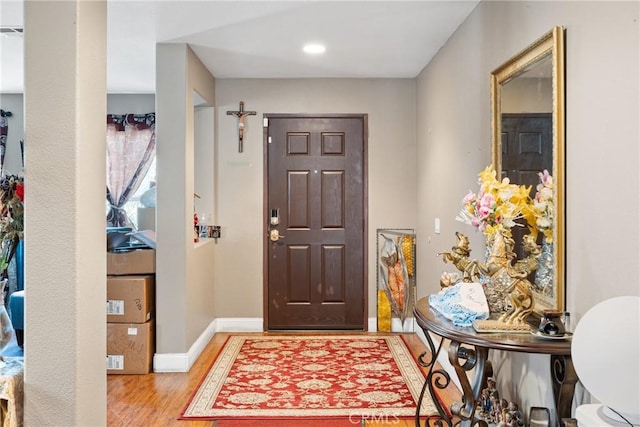 entrance foyer featuring light wood-type flooring and baseboards