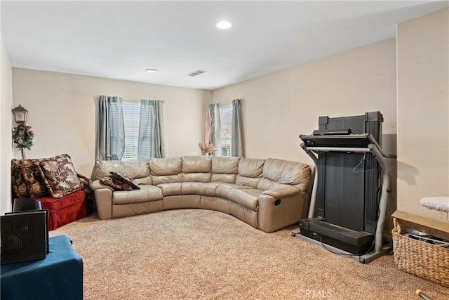 carpeted living area featuring visible vents and recessed lighting