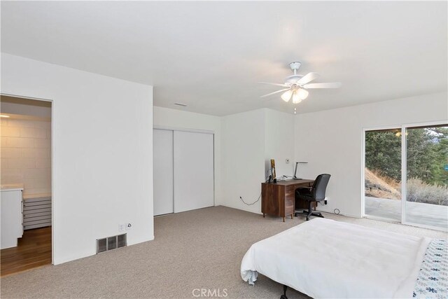 bedroom featuring access to exterior, ceiling fan, a closet, and carpet