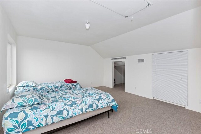 carpeted bedroom featuring vaulted ceiling