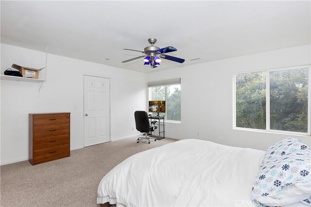 bedroom with ceiling fan and light carpet