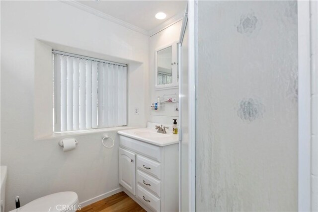 bathroom with vanity, hardwood / wood-style flooring, toilet, and crown molding