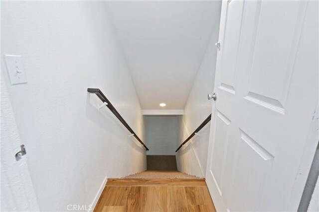 staircase with wood-type flooring