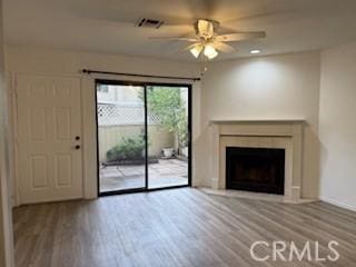 unfurnished living room featuring ceiling fan and wood-type flooring