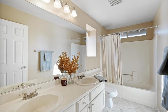 full bathroom with tile patterned floors, shower / tub combo with curtain, vanity, and toilet