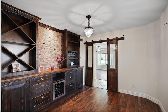 bar with dark wood-type flooring, an inviting chandelier, hanging light fixtures, dark brown cabinets, and butcher block counters