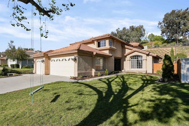 mediterranean / spanish home with a garage and a front yard