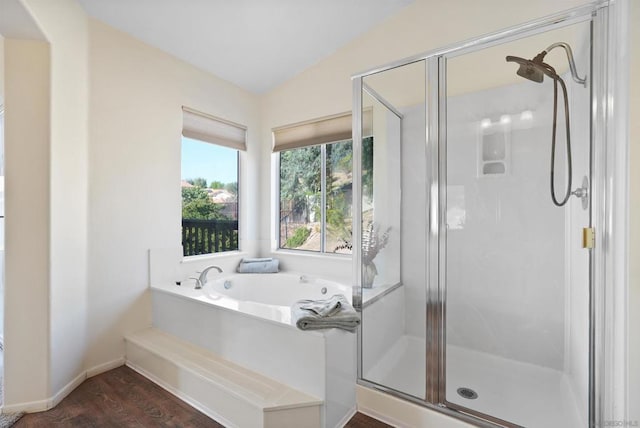 bathroom with hardwood / wood-style flooring, lofted ceiling, and shower with separate bathtub