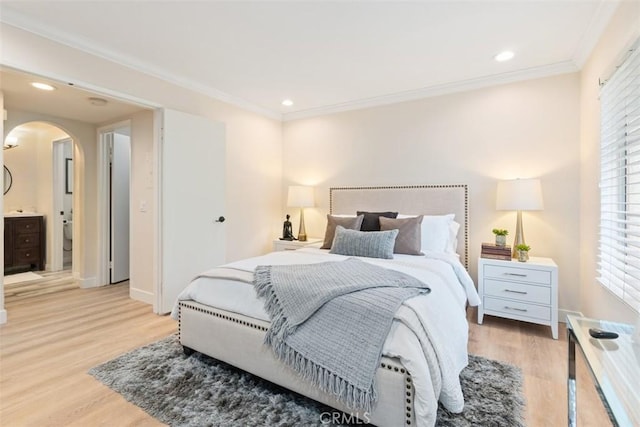 bedroom with ornamental molding and light hardwood / wood-style floors