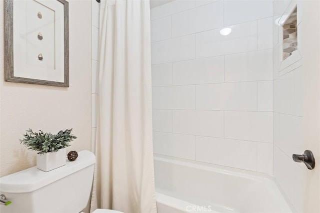 bathroom featuring toilet and shower / bath combination with curtain