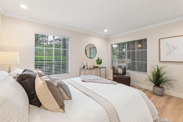 bedroom with crown molding and light hardwood / wood-style floors