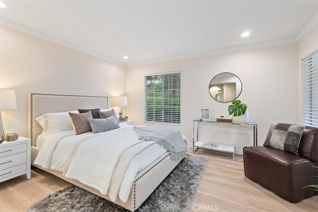 bedroom featuring light hardwood / wood-style flooring and ornamental molding