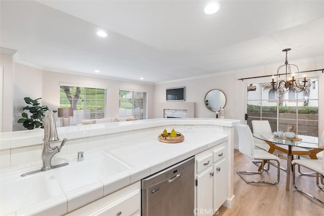 kitchen with white cabinets, dishwasher, light hardwood / wood-style flooring, and tile counters