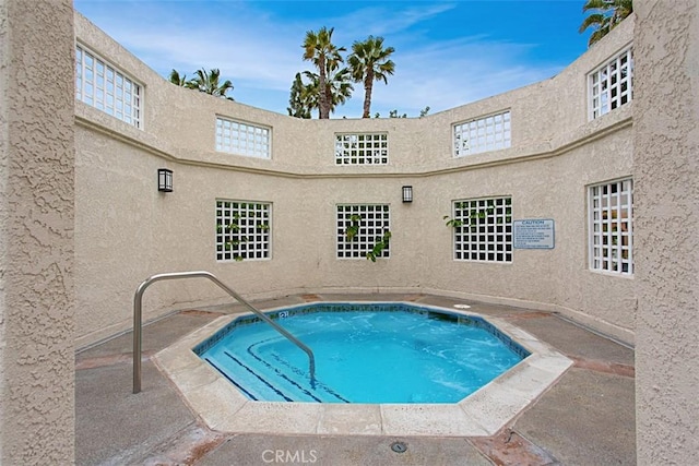 view of swimming pool featuring a community hot tub