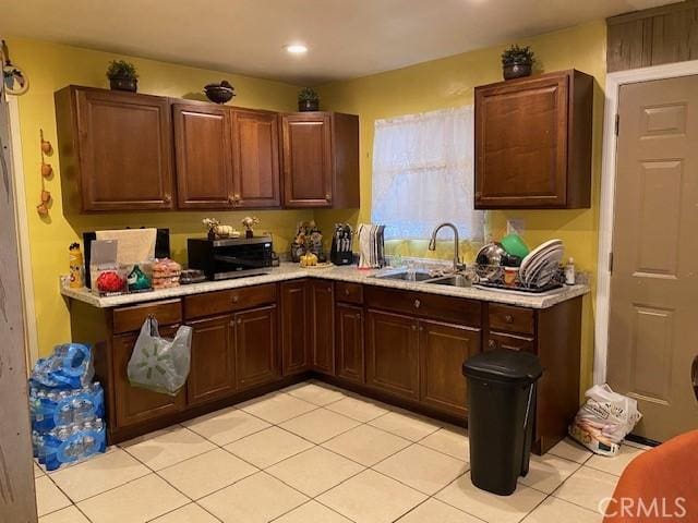 kitchen featuring sink and light tile patterned flooring