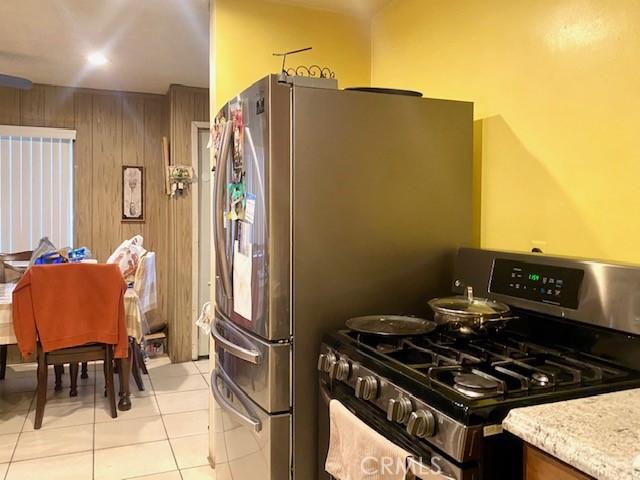 kitchen with appliances with stainless steel finishes and light tile patterned flooring