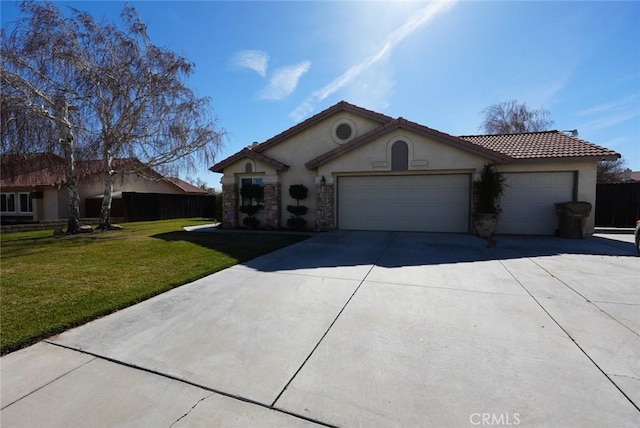 view of front of property featuring a front yard and a garage