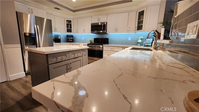 kitchen featuring white cabinets, appliances with stainless steel finishes, and light stone countertops