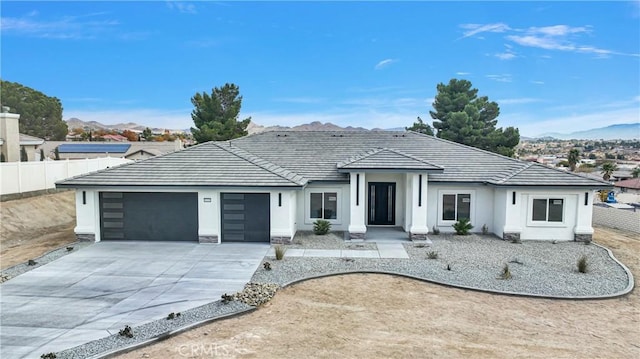 view of front of home featuring a mountain view and a garage