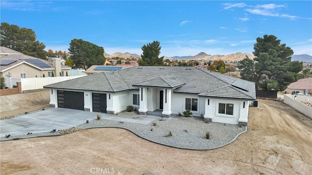 ranch-style home with a mountain view and a garage