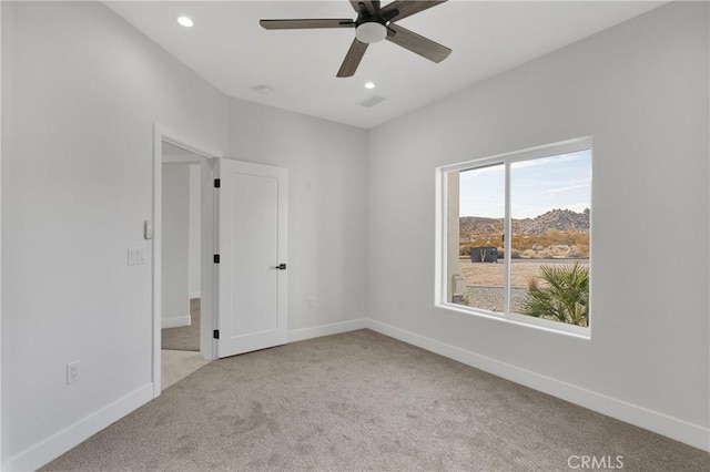 carpeted empty room with ceiling fan