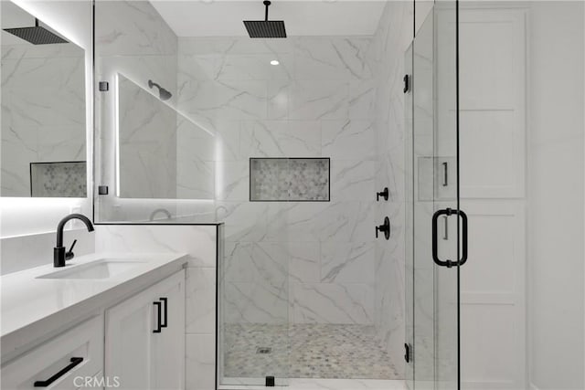 bathroom featuring vanity and a shower with shower door