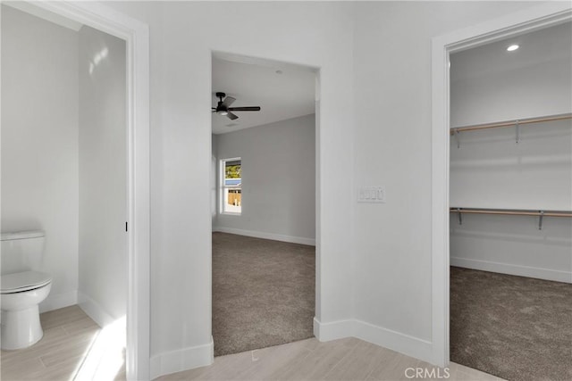 bathroom with ceiling fan and toilet