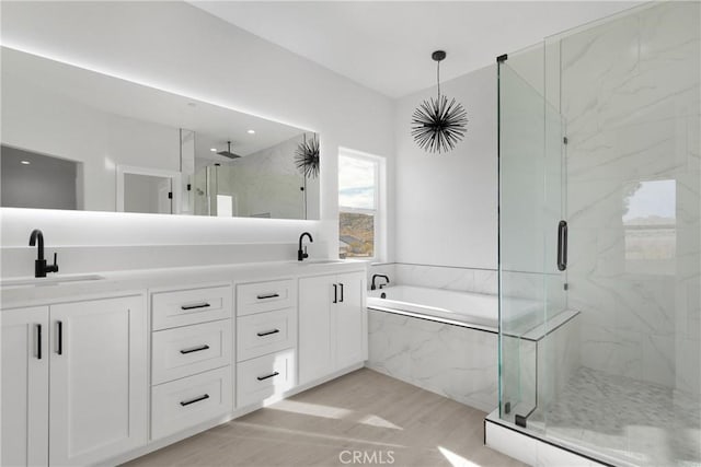 bathroom featuring vanity and shower with separate bathtub