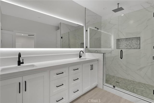 bathroom featuring vanity and a shower with shower door