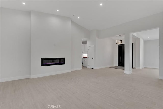 unfurnished living room featuring light wood-type flooring