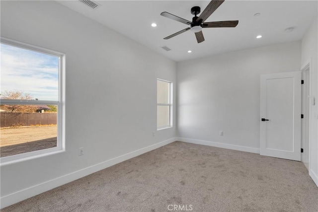 empty room with ceiling fan and light colored carpet