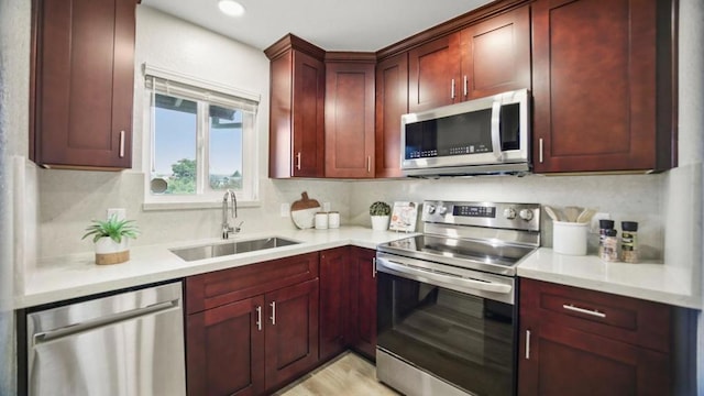 kitchen featuring decorative backsplash, appliances with stainless steel finishes, and sink