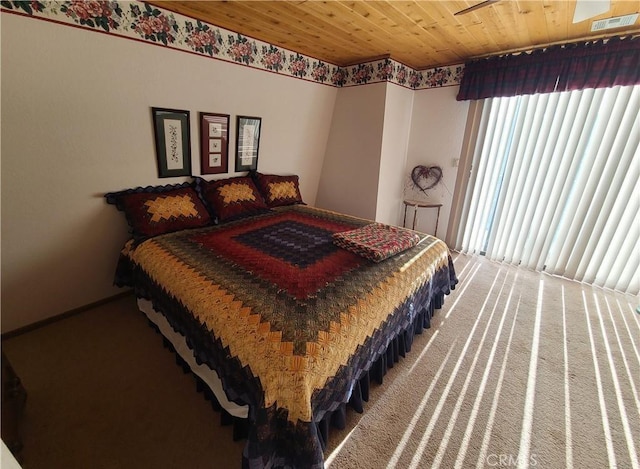 carpeted bedroom with wood ceiling