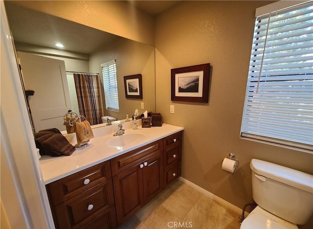 bathroom with vanity, tile patterned floors, toilet, and walk in shower