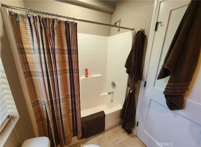 bathroom featuring tile patterned flooring and shower / bath combo