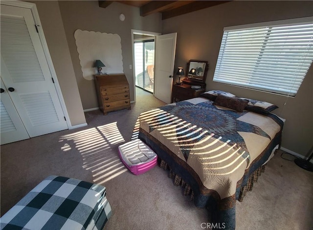 carpeted bedroom with beam ceiling