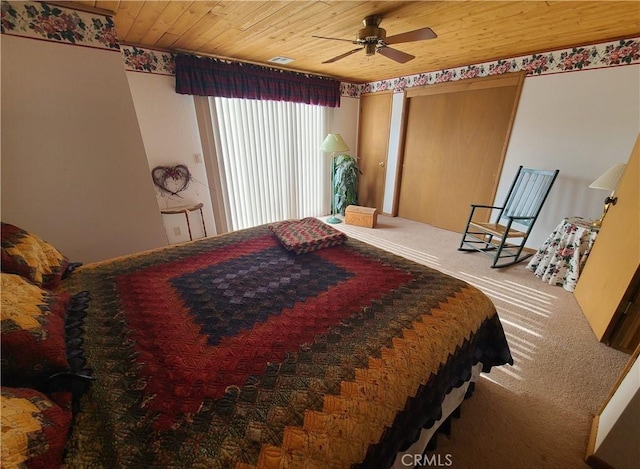 bedroom featuring wood ceiling and carpet floors