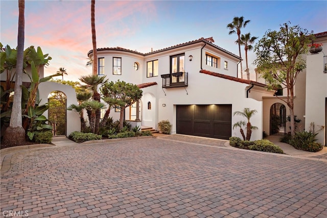 mediterranean / spanish-style house with a garage