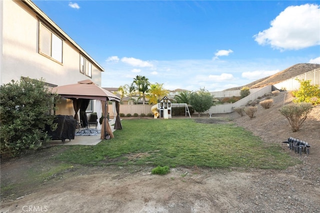 view of yard featuring a gazebo and a playground