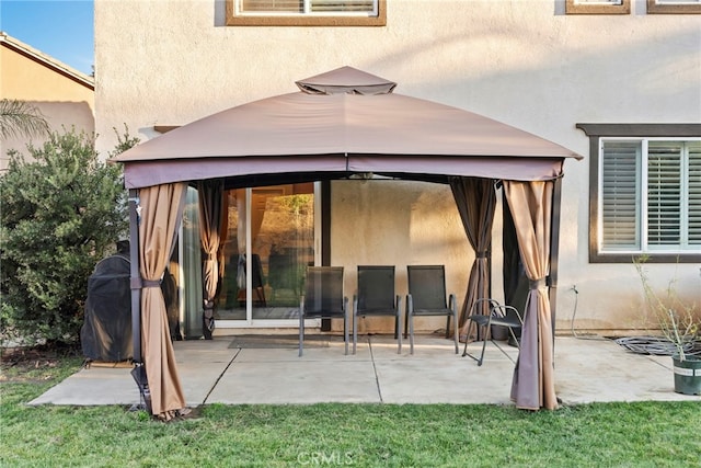 rear view of house featuring a patio area and a gazebo